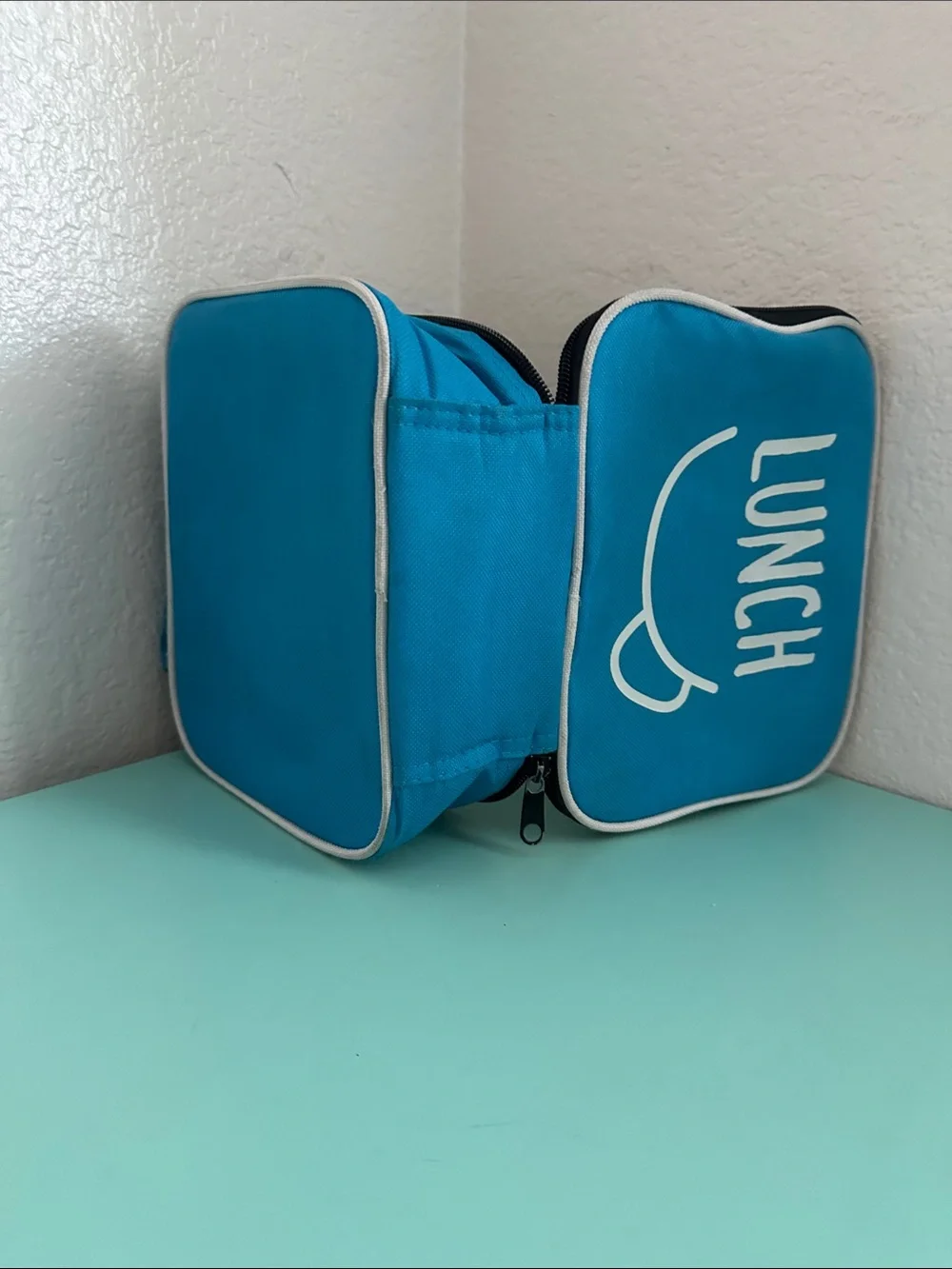 Walmart blue insulated lunch box with a minimalist white ’LUNCH’ graphic-used